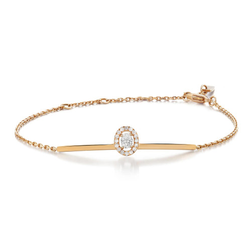 An image of a Messika women's Glam'Azone chain bracelet with diamonds, presented on a plain white background. The bracelet is captured from a top view at eye level, centered horizontally in the frame. It features a delicate 18k rose gold chain with a central bar design, and a prominent circular diamond cluster set in the middle. The photo is taken at a close distance, showcasing the intricate details and sparkle of the diamonds, with the entire piece in sharp focus against the contrasting background.