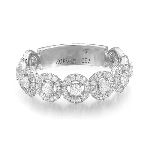 An image of a Messika brand women's All Joy band ring with diamonds. The ring is centered and viewed from a top angle, showcasing a series of large, round-cut diamonds encircled by smaller diamonds set in a polished 18k white gold band. The diamonds are arranged in a symmetrical pattern across the front half of the band, with clear engravings visible inside the band. The image is taken from a close distance, providing a detailed view of the intricate design and sparkling stones.