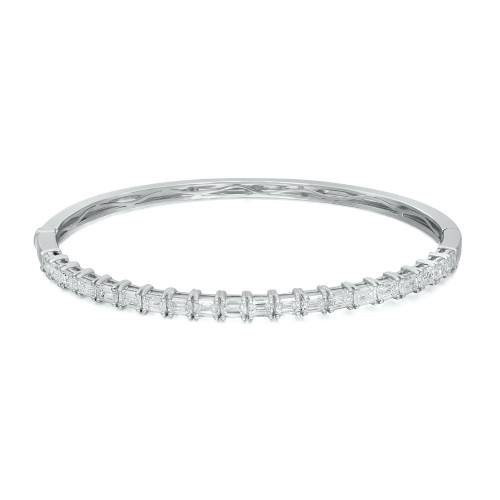 An image of a Rachel Koen women's bangle bracelet with diamonds, displayed in a close-up front view on a neutral background. The bracelet is positioned horizontally across the frame with a slight angle, showcasing a row of sparkling emerald cut diamonds set in a polished white gold. The focus is on the intricate details and craftsmanship, with the diamonds catching the light, providing a clear view of the bracelet's luxurious design.
