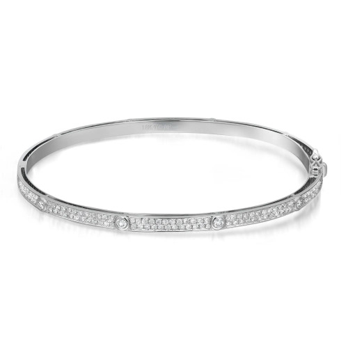 An image of a Rachel Koen women's bangle bracelet with diamonds, showcased in a close frontal view against a white background. The bracelet is presented in a slight left-angled position, allowing the row of neatly set round cut diamonds along the top surface to catch the light and sparkle. The bracelet's band is a slim, polished silver tone, marked with "18K 750 KF" indicating its quality, and the clasp is visible on the right side in white gold. The image is taken from a medium distance, providing a clear view of the bracelet's design and the intricate details of the diamonds.