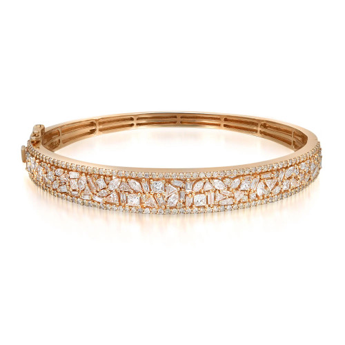 An image of a Rachel Koen women's bangle bracelet with diamonds, displayed in a close-up, front-view shot. The bracelet is positioned horizontally across the center of the frame, showcasing its intricate design. The yellow gold bracelet is encrusted with multiple sparkling diamonds, featuring a mix of round, baguette and marquise cuts that catch the light. The bracelet's clasp is subtly visible to the left, blending seamlessly with the overall design. The background is a neutral, light color that highlights the bracelet's radiance and craftsmanship.
