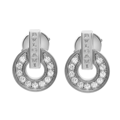 An image of a pair of Bvlgari Bvlgari Openwork 18k white gold women's earrings with diamonds, shown from a front-facing angle. They are positioned centrally and displayed against a white background. Each earring features a loop design encrusted with sparkling diamonds, with the brand name 'BVLGARI' engraved on the upper metal section. The image is taken from a close distance, providing a clear view of the earrings' intricate details and the reflective quality of the diamonds. The condition of earrings are new. 