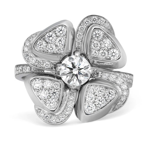 An image of a Bvlgari Fiorever ring designed for women, featuring a central round-cut diamond prominently set at the center of four petal-like formations. Each petal is inlaid with multiple smaller diamonds, creating a sparkling floral motif. The ring is presented in a close-up view with a direct, frontal angle that highlights the intricate details and the brilliance of the diamonds. The white gold setting enhances the diamonds' radiance, and the image is taken from a distance that captures the entire design of the ring in sharp focus against a white background. The condition of the ring is new. 