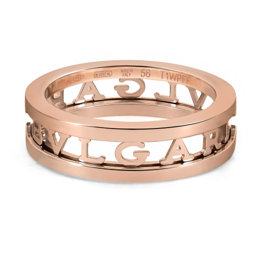 An image of a Bvlgari B.Zero1 Openwork Logo Spiral unisex adult one band ring without stones, captured in a close-up view. The ring, presented at a slight angle, showcases a polished rose gold finish with the brand's name cut out around the circumference. The background is a plain white surface, emphasizing the intricate details and craftsmanship of the ring. The condition of the ring is new. 