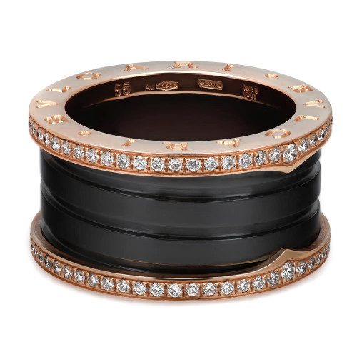 An image of a Bvlgari B.Zero1 unisex adult ring with diamonds, presented in a close-up view at a slight angle. The ring features a stacked design with black ceramic four bands, the central bands are black, flanked by rose gold bands adorned with sparkling diamonds. The rose gold elements have a polished finish that contrasts with the black bands, emphasizing the diamonds' brilliance. The ring is centered and occupies a majority of the frame, showcasing intricate details and craftsmanship.