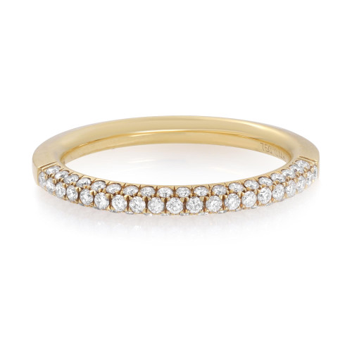 An image of a Piero Milano women's wedding ring with diamonds, displayed in a close-up side view that showcases a continuous three row band of sparkling round cut diamonds set in a yellow gold band. The ring is positioned horizontally across the center of the frame with the focus on the diamond-encrusted top half, against a white background. The perspective is head-on, ensuring the diamonds' brilliance is visible.