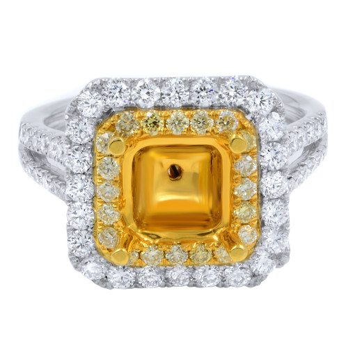 An image of a Rachel Koen brand cushion set mounting set in a yellow gold for women, surrounded by a double halo of smaller white diamonds. The outer halo is set in white gold metal, and the ring is positioned centrally against a white background, with the band partially visible as it curves on either side. The ring is shown in close-up, capturing the brilliance and details of the diamonds.