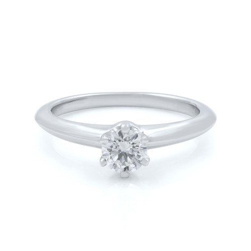 An image of a Tiffany & Co. women's engagement ring with diamond, positioned centrally and viewed from a top-front angle. The ring features a polished platinum band with a single large diamond set in a six-prong setting. The photo is taken from a close distance, focusing on the diamond and the upper portion of the band, against a white background.