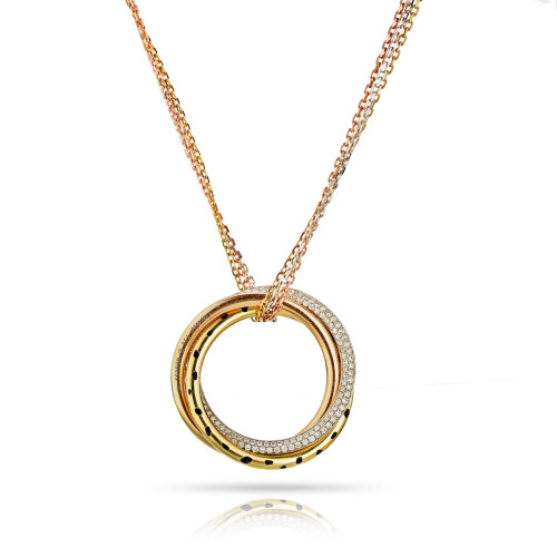 An image of a Cartier women's Tri Color Trinity Panthere Pendant necklace with diamonds, centered and shown up close. The necklace features a multi-layered circular pendant with yellow gold outer ring and a smaller concentric ring adorned with diamonds. The inner ring is yellow gold with black enamel, and the pendant is suspended from a yellow gold chain. The image is taken from a front-facing angle, showcasing the sparkle of the diamonds and the intricate design of the pendant against a white background with a subtle reflection beneath. Comes in a great preowned condition.