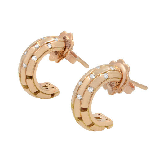 An image of a pair of Piero Milano women's huggie earrings with diamonds, displaying a front-facing view. The earrings are crafted in a rose gold and feature a curved huggie design. They are set with multiple small, round-cut diamonds evenly spaced along the outer edge. The earrings are positioned parallel to each other with a slight angle, showcasing the sparkle of the diamonds. The image is taken from a close distance to capture the intricate details of the earring's design and the diamonds' placement.