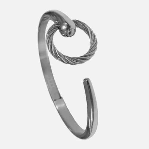 An image of a Charriol brand unisex adult bracelet without stones. The bracelet is presented at a three-quarter angle with the focus on the center, showing the distinctive twisted cable design looped through a polished, silver-tone stainless steel metal end cap. The bracelet's band, with a smooth, reflective finish, curves outward from the bottom of the frame toward the upper right, suggesting an open cuff style. The Charriol logo is subtly embossed on the metal near the lower left edge of the frame, and the image is taken at a close distance to capture detail while maintaining a full view of the bracelet. Bracelet size is medium.