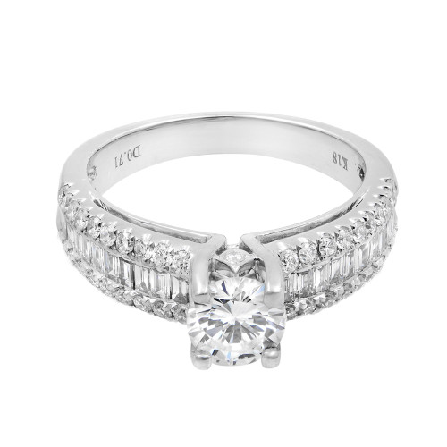 An image of a Rachel Koen women's white gold engagement ring with diamonds, captured from a top-down perspective. The ring is centered in the frame, showcasing a prominent round brilliant-cut diamond set in a four-prong setting. The band is adorned with a channel of smaller round diamonds on its sides and is polished to a high shine, reflecting light. The view is close enough to reveal the intricate details of the diamond's facets and the ring's craftsmanship.