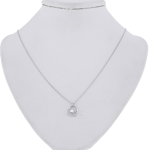 An image of a Hearts on Fire Brocade Heart single diamond women's pendant necklace, displayed on a white necklace stand. The necklace features a delicate white gold chain with a diamond-encrusted pendant at the center. The pendant is positioned at the base of the stand's neck, and the image is taken from a front-facing angle at close distance, showcasing the sparkle and design of the diamonds clearly.