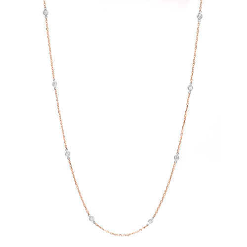 An image of a Rachel Koen brand diamond by the yard women's necklace set in 14k rose gold with white gold bezel setting. The necklace is displayed against a white background and is positioned in a slight S-curve, showing the full length of the chain. The perspective is head-on and the necklace is centered in the frame, providing a clear and detailed view at a medium distance.