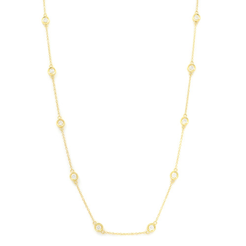 An image of a women's diamonds by the yard necklace by Rachel Koen, featuring a delicate yellow gold chain adorned with evenly spaced diamonds set in round bezels. The necklace is displayed against a plain white background, captured from a straight-on angle. The photograph is taken at a medium distance to highlight the detailed craftsmanship of the diamond settings along the chain.