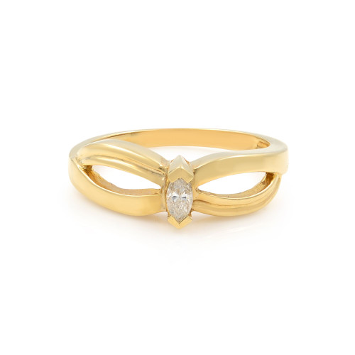 An image of a women's yellow gold engagement ring by Rachel Koen, featuring a marquise-cut diamond set in the center. The ring is positioned upright and viewed from a slightly elevated angle, showcasing its elegant band design with a bow-like shape. The image is taken at a close distance, highlighting the shiny gold finish and intricate detailing around the diamond.