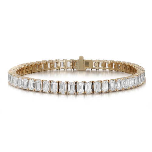An image of a unisex adult bracelet by Rachel Koen, featuring a row of sparkling emerald cut lab grown diamonds set in yellow gold in prong setting. The bracelet is positioned horizontally, viewed from a slight angle above, showcasing the intricate diamond design and clasp. The image is captured at a moderate distance, highlighting the elegance and detail of the piece.