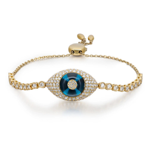An image of a Rachel Koen unisex adult bracelet with diamonds. The bracelet is displayed at eye level and centered in the frame, showcasing its intricate design. It features a prominent central blue glass surrounded by a halo of diamonds, with a series of smaller diamonds adorning the band in yellow gold. The background is plain, highlighting the elegant details of the bracelet.