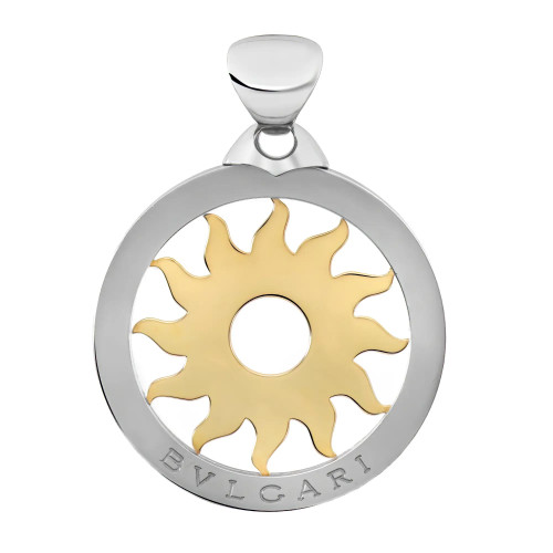 An image of a Bvlgari unisex adult pendant without stones. The design features a circular pendant with a polished outer stainless steel ring and a yellow gold sun motif at the center. The brand name "BVLGARI" is engraved at the bottom of the outer ring. The pendant is displayed from a front angle, closely centered, showcasing the intricate details of the pendant's design.