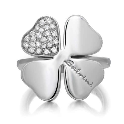 An image of a women's ring by Salvini featuring a four-leaf clover design. The ring is viewed from the front at a close distance, highlighting the intricate diamond arrangement on one petal. The brand name "Salvini" is engraved on another petal, with the white gold surface reflecting light elegantly.