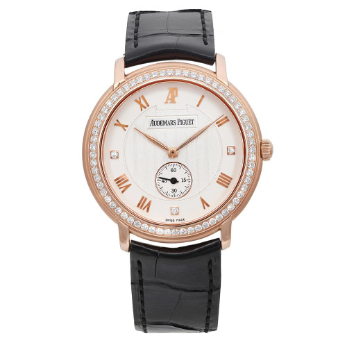This image presents a close-up, straight-on view of a pre-owned men's Audemars Piguet Jules wristwatch. The watch boasts an 18k rose gold case with a diamond-set bezel, a silver dial with Roman numeral hour markers, and a small seconds subdial at the 6 o'clock position. It features a factory diamond dial and bezel. There are micro scratches on the dial. The elegant black leather strap, which is unworn, is visible at the top and bottom of the image
