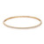 An image of a Rachel Koen women's bracelet with round cut diamonds. The bracelet is positioned horizontally in the center of the frame with a front-facing view, highlighting a row of sparkling diamonds set along the top edge. The bracelet is crafted in yellow gold and is photographed from a close distance against a white background, allowing clear visibility of the diamonds' facets and the bracelet's intricate design.