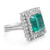 An image of a Rachel Koen women's cocktail ring, viewed at a close distance and angled slightly to show the top and side profiles. The ring features a prominent, square-cut Emerald in a deep green color, set in the center and surrounded by a double halo of sparkling round-cut diamonds. The band is made of polished 18k white gold, splitting into multiple strands as it approaches the halo setting.