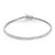 An image of a Rachel Koen unisex adult tennis bracelet with prong set round cut diamonds, displayed against a white background. The bracelet is positioned in a slight curve with the clasp partially open and oriented towards the top right corner. The diamonds are set in a continuous line around the white gold bracelet, catching the light to showcase their brilliance. The photograph is taken from a top-down angle at a close distance, providing a clear view of the individual diamond settings and the overall design of the piece.