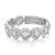 An image of a Messika women's ring with diamonds, displayed in a close-up, frontal view. The ring features multiple circular elements adorned with sparkling diamonds, set in a reflective silver-toned band that is angled slightly to the right, creating a gentle curve visible to the viewer. The diamonds catch the light, showcasing their brilliance and the intricate setting. The background is a soft, blurred white, emphasizing the ring's detail and craftsmanship.