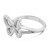 An image of a women's Messika brand ring with diamonds, showcased against a white background. The ring is positioned at a slight angle, allowing a clear view of the intricate bow-shaped design at the top, which is adorned with numerous small diamonds. The ring's band, visible from the side, features the engraved brand name "MESSIKA PARIS." The image is taken from a medium distance, focusing on the ring to highlight the sparkle of the diamonds and the polished white gold finish of the metal.