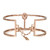 An image of a Messika women's bracelet with diamonds. The bracelet is showcased in a frontal view with a slight angle to give depth to the design. It is placed against a neutral background, positioned centrally and at a close distance to allow for clear visibility of details. The rose gold bracelet features a sleek, modern design with a geometric pattern and a delicate chain with a heart-shaped charm and tag. Sparkling diamonds are visible, accentuating the bracelet's elegance.