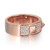 An image of a rose gold Messika ring designed for women, featuring a band with a broad, flat surface. The ring is positioned centrally and viewed from a slightly top-down angle, showcasing a detailed section with pavé-set diamonds and a larger, bezel-set diamond in a triangular recess. The Messika brand name is engraved on the smooth, polished interior of the band, which is visible at the top of the image. The close-up shot captures the sparkle of the diamonds and the pinkish hue of the rose gold.