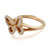 An image of a Messika women's ring with diamonds, showcasing a rose gold band with a butterfly-shaped ornament adorned with sparkling diamonds. The ring is photographed at a close-up angle, with the butterfly positioned diagonally across the image, its wings extending to the upper left and lower right corners. The band is visible to the lower left, with the brand name 'MESSIKA' engraved on it, indicating the ring's orientation on a finger. The image is taken against a white background, highlighting the ring's design and brilliance.