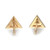 An image of a pair of Messika women's Thea stud earrings with diamonds, showcased on a white background. The earrings are shaped like inverted triangles and are positioned side by side with a slight gap between them, angled to display the brand engravings on the back side. The camera is in a direct overhead position, providing a clear and close view that highlights the gold finish and embedded diamonds.