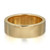An image of a polished yellow gold Messika women's ring with diamonds. The ring is presented in a close-up, centered view against a white background. The band is wide with a smooth, shiny finish, and the diamonds are subtly inset along the edge at regular intervals. The perspective is slightly angled, highlighting the ring's thickness and the gleam of both the metal and the gemstones. The distance is such that the entire ring is in focus, allowing for detailed observation of its design and craftsmanship.