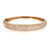 An image of a Rachel Koen women's bangle bracelet with diamonds, displayed in a close-up, front-view shot. The bracelet is positioned horizontally across the center of the frame, showcasing its intricate design. The yellow gold bracelet is encrusted with multiple sparkling diamonds, featuring a mix of round, baguette and marquise cuts that catch the light. The bracelet's clasp is subtly visible to the left, blending seamlessly with the overall design. The background is a neutral, light color that highlights the bracelet's radiance and craftsmanship.