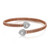 An image of a Rachel Koen women's open bypass bracelet with diamonds, displayed at a three-quarter angle to showcase its design. The bracelet is positioned centrally in the frame and appears to be a close-up view, providing a clear representation of the rose gold flexible band and the two heart-shaped accents encrusted with round and baguette cut diamonds, set at opposite ends of the band.
