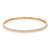 An image of a Rachel Koen women's bracelet with diamonds, displayed in a close-up frontal view on a white background. The bracelet has a circular shape and is oriented horizontally across the frame, showcasing a row of sparkling diamonds set in a polished yellow gold band with intricate detailing visible on the inner side. The piece is shown in sharp focus, capturing the brilliance of the diamonds and the craftsmanship of the design.