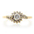 An image of a Rachel Koen brand women's ring with diamonds, displaying a central large round cut diamond surrounded by smaller round diamonds set in a flower-like pattern. The ring is shown from a top view with the band extending horizontally across the frame, providing a clear view of the intricate design. The ring is crafted with a yellow gold band and the diamonds are mounted with a mix of prong and bezel settings. The image is taken from a close-up angle to highlight the details of the diamonds and the setting. The ring is pre owned in great condition. 