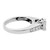An image of a Rachel Koen brand ring for women, featuring diamonds. The ring is displayed at a 45-degree angle to the camera, with the band partially visible and the diamonds set in a row on the side facing the viewer. The focus is on the upper part of the ring, showing the reflective white go finish and the clarity of the diamonds. The background is a neutral white, emphasizing the ring's design and sparkle. The image is taken at a close distance, allowing for a clear view of the ring's details.