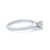 An image of a Tiffany & Co. women's engagement ring with diamond, captured from a side angle at a close distance. The ring features a polished platinum band with the brand's signature inscribed on the inner surface, leading up to a prominent solitaire diamond held securely in a six-prong setting. The focus is on the diamond and the upper part of the band, highlighting the stone's brilliance and the ring's elegant design. The background is a neutral white, ensuring that the ring stands out clearly.