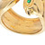 An image of a vintage Cartier Anoubois women's ring with gemstones focused on the inner band showing the engraved Cartier brand name and numeric markings. The ring is viewed from a close distance at a slightly tilted angle, with soft lighting that highlights the yellow gold band's engraved details. The gemstone is partially visible at the top edge, with a glimpse of its green color. Comes in a great preowned condition.