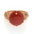 An image of a new Luca Carati women's cocktail ring with a central large red Agate gemstone surrounded by diamonds. The ring is positioned directly facing the camera at a close distance, providing a clear view of the stone's smooth surface and the intricate design of the rose gold band with embedded round cut diamonds. The angle of the shot is head-on, capturing the ring's details and craftsmanship.