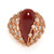 An image of a new Luca Carati women's cocktail ring featuring a large, pear shaped, central red Agate gemstone with a glossy finish, set in a rose gold band. The band is intricately designed with multiple small round diamonds encrusted around it, creating a sparkling halo effect in rose gold. The ring is photographed from a top-down perspective at close range, highlighting the gemstone's smooth surface and the surrounding diamonds' brilliance.