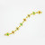 An image of a women's bracelet by Catherine Mullen laid out against a white background. The bracelet extends diagonally from the bottom left corner to the upper right corner of the frame, positioned close-up and centered in the image. This luxurious piece features a series of yellow gold links, each adorned with diamonds and ruby, emerald and sapphire gemstones, providing a vibrant contrast against the golden setting.