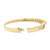 An image of a women's bracelet by Rachel Koen, featuring diamonds set in a yellow gold band. The bracelet is displayed in a side profile view, slightly elevated, showcasing its open clasp on the left. The diamonds are embedded along the visible section, with a soft shadow beneath. The image captures the bracelet from a close distance, highlighting its elegant design and luxurious finish.Excellent pre-owned condition. 