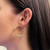 An image of a woman's ear adorned with a gold hoop earring, viewed from the side. The earring is smooth and circular, without any stones, and positioned close to the ear. The image is taken at a close angle, highlighting the earring's simple and elegant design against the background of straight dark hair.Excellent pre-owned condition. 