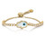 An image of a unisex adult bracelet by Rachel Koen, featuring diamonds. The bracelet is positioned at a slight angle, showcasing its intricate design. At the center is a decorative element resembling an eye, surrounded by a series of circular diamonds set in yellow gold. The image captures the bracelet from a close distance, highlighting the texture and sparkle of the materials.