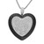 An image of a heart-shaped necklace pendant adorned with white and black diamonds. The pendant is centered and angled slightly forward, showcasing the intricate pattern of diamonds in white gold. The chain is visible at the top, emphasizing the pendant's elegance. The photo is taken close-up, highlighting the sparkle and detail of the diamonds.