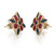 An image of a pair of women's earrings by Rachel Koen, featuring a symmetrical design with rubies and blue sapphire gemstones set in a yellow gold metal. The earrings are positioned upright, angled slightly towards each other, and viewed from a close-up perspective, highlighting the intricate details and vibrant colors of the gemstones.